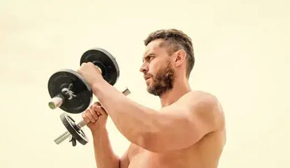 Man lifting dumbbells outdoors, showcasing strength and fitness, symbolizing benefits of living foods for men on TRT.