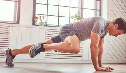 Man performing mountain climbers in a bright room, highlighting fitness for enhancing hormone support alongside TRT and nutrition.